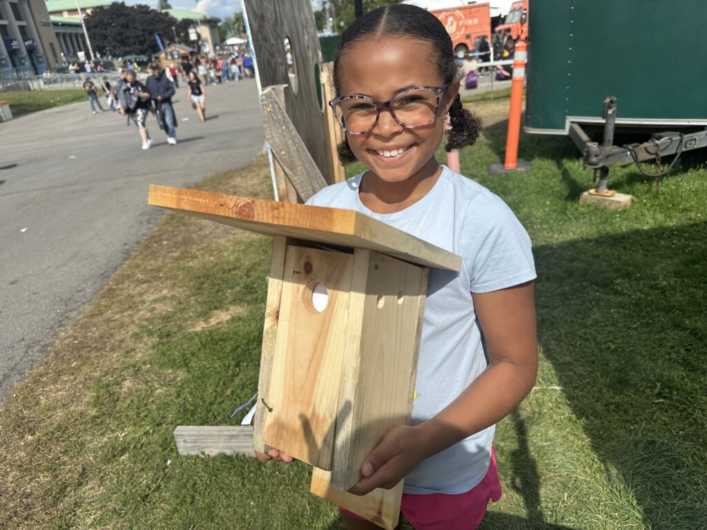 Dayana HIlgenberg holds a bird house she intends to place in her backyard where hummingbirds flit.