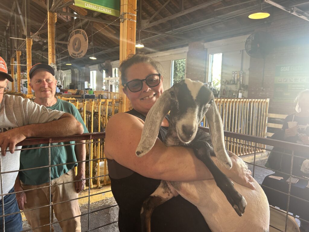Michelle Bishop-Utano holds Ororo Storm, a goat that fair-goers could possibly win.
