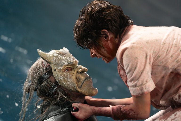 Black Phone Grabber held by the collar by bloody girl