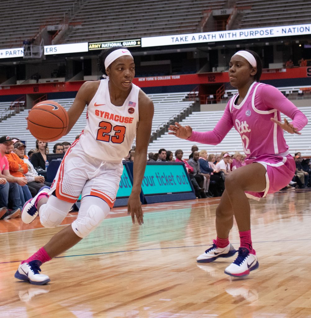 Syracuse University's guard, Kiara Lewis, 23, pushes past a University of Pittsburgh defender during a college basketball game on February 16, 2020.