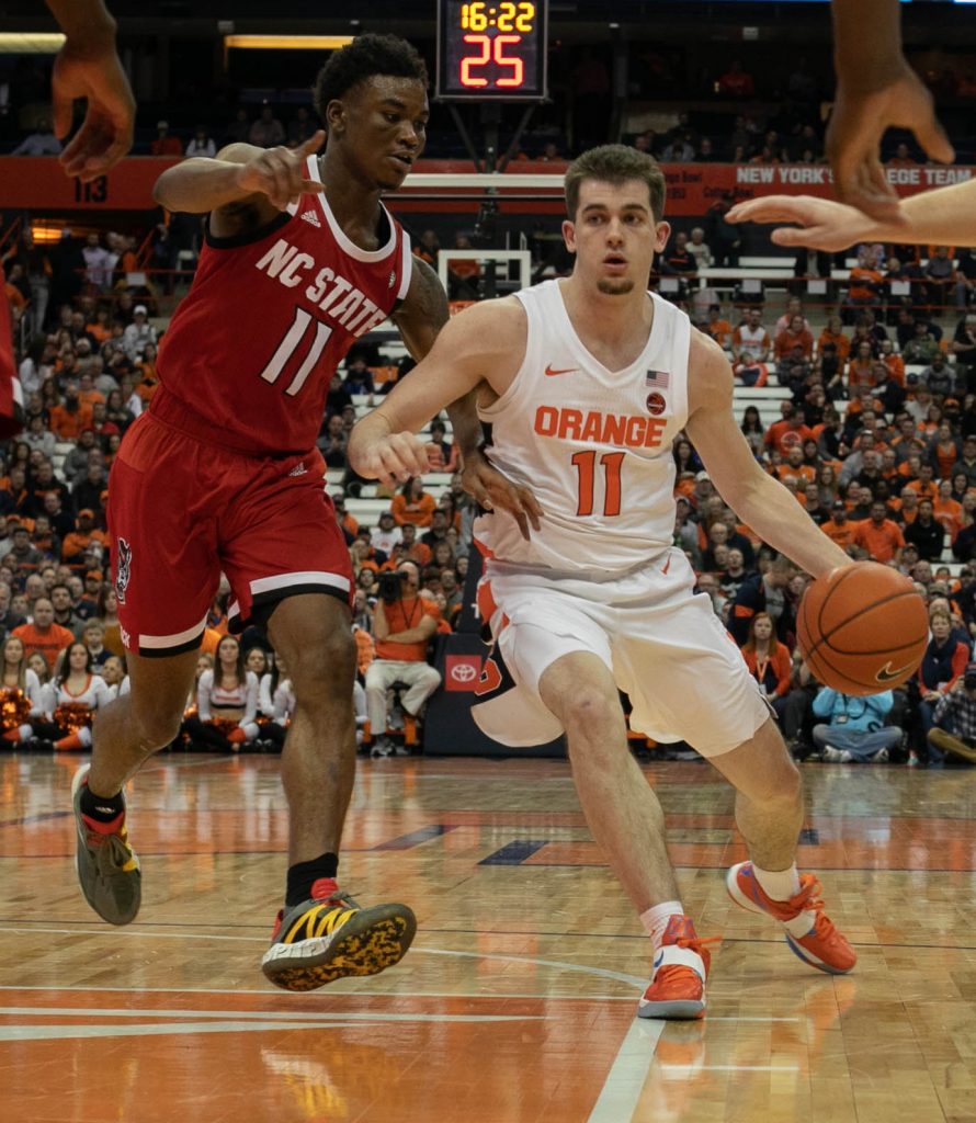 Joseph Girard III cuts through various NC State players of Syracuse Men's Basketball's Feb. 11 game vs. NC State Wolfpack in the Carrier Dome.
