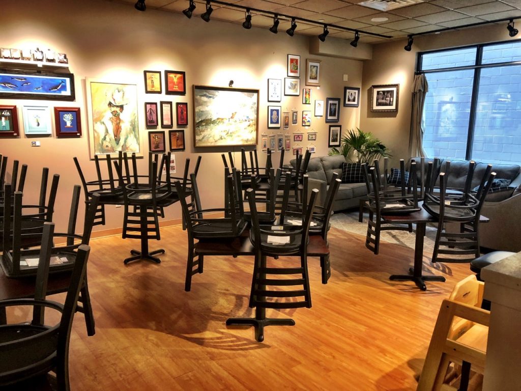 Chairs stacked on tables inside Saratoga Deli