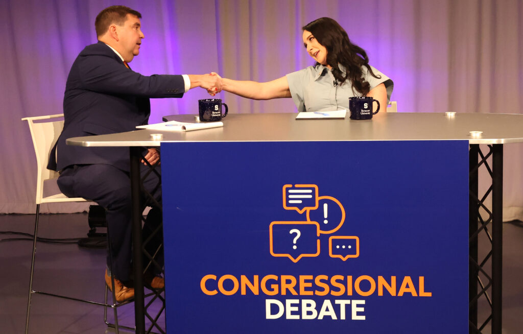 Incumbent Rep. John Mannion (New York-22) shakes hands with challenger Kailee Buller during their congressional debate at the Newhouse School of Public Communications studios on Oct. 5, 2026.
