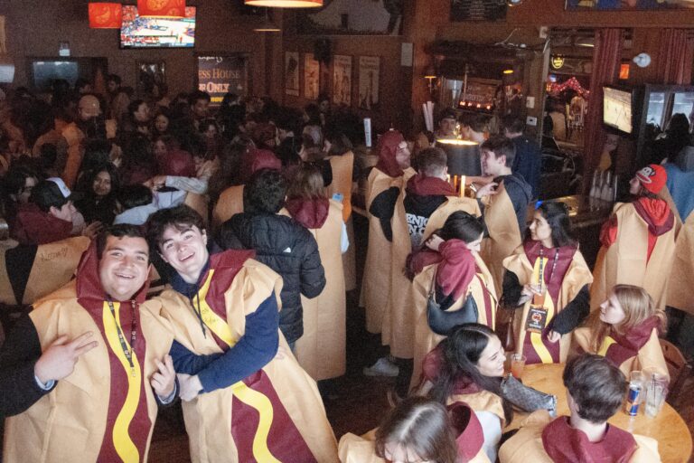 People dressed as hot dogs in a bar