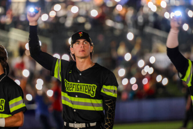 Firefighters right-handed pitcher Bradford Webb (42) holding a flashlight as fans light up the stadium with their flashlights during Banana Ball game against the Texas Tailgaters on Friday, September 11th, 2026 at NBT Bank Stadium.