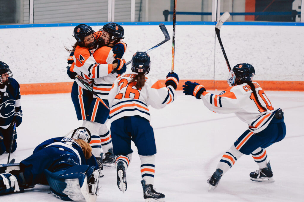 Jordan Blouin embraces a teammate after her second goal against Penn State in the 13th minute of the 2nd period during Syracuse women's ice hockey against Penn State on Friday, Oct. 9, 2026, at Tennity Ice Pavilion.