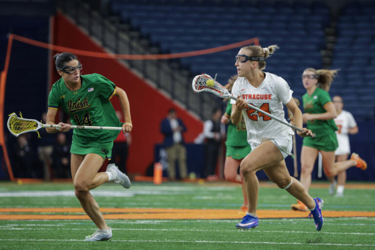 Syracuse attacker Caroline Trinkaus drives against the Notre Dame defense at the JMA Wireless Dome on Saturday, April 11, 2026.