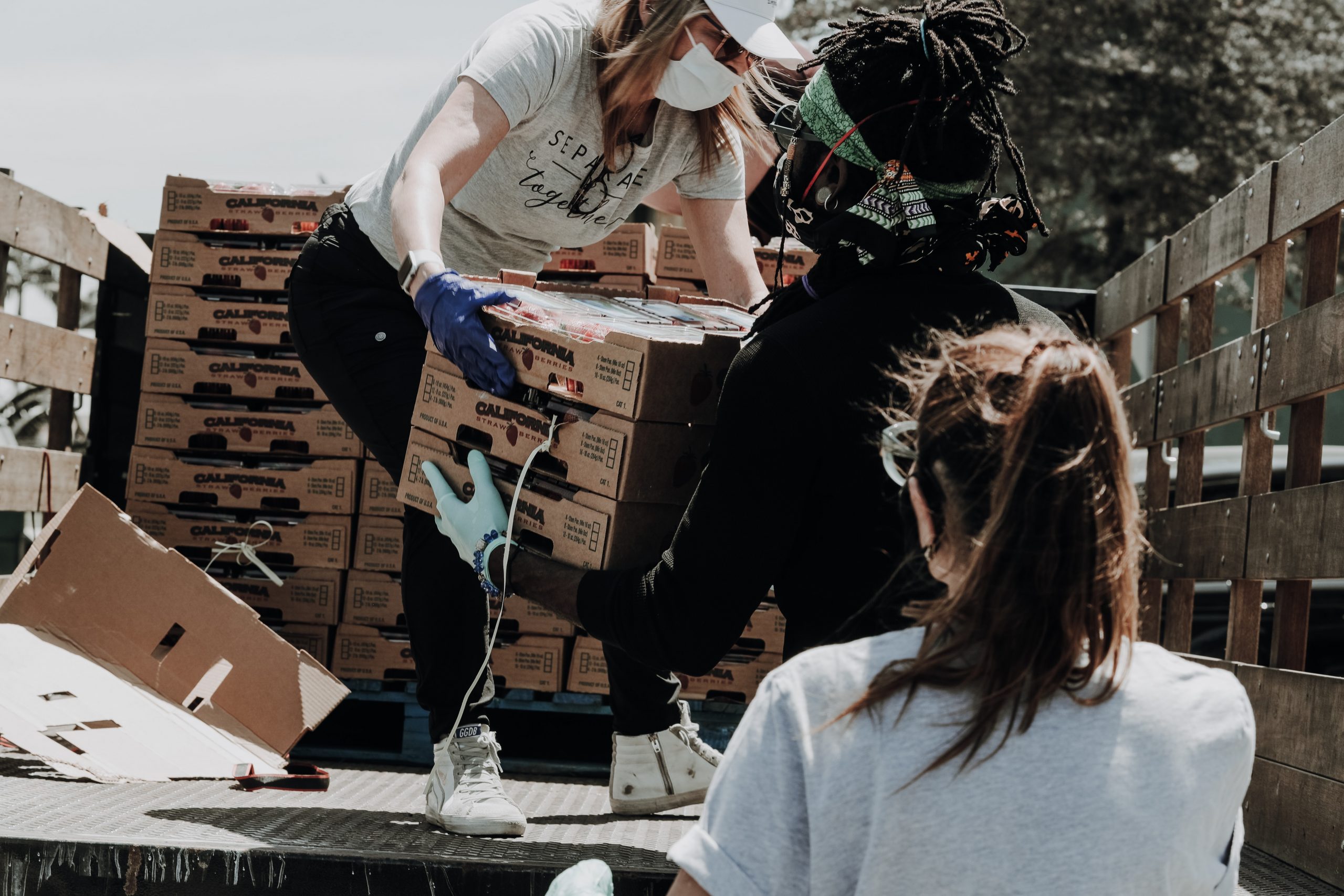 Volunteers helping unload a truck.