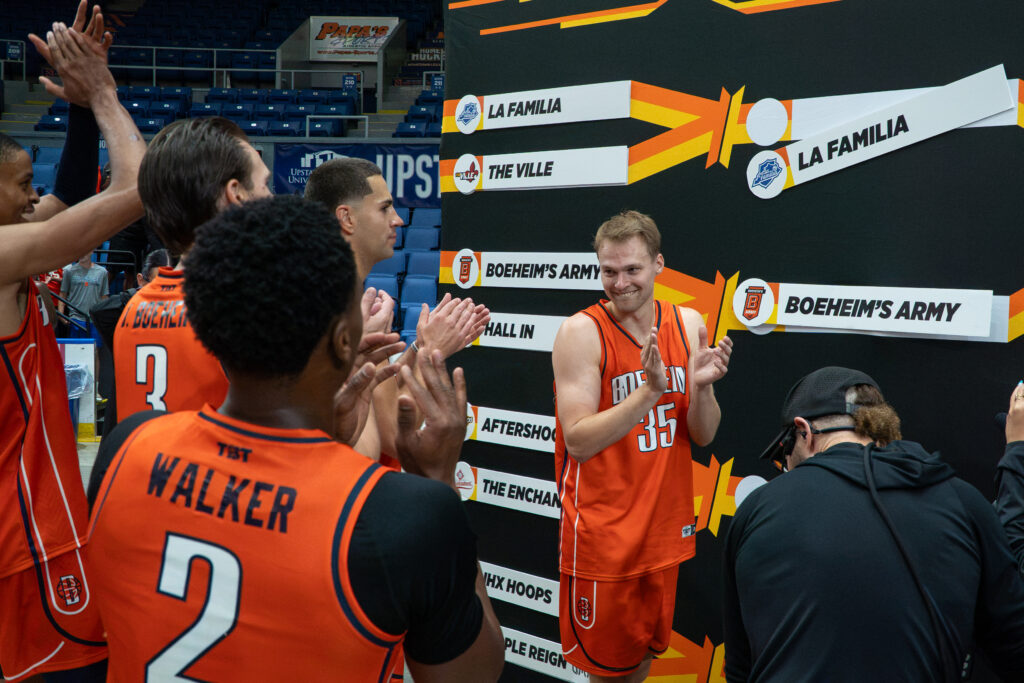 Buddy Boeheim places the Boeheim's Army placards on the tournament board after Thursday's first round game of The Basketball Tournament at the Upstate Medical Arena at War Memorial.