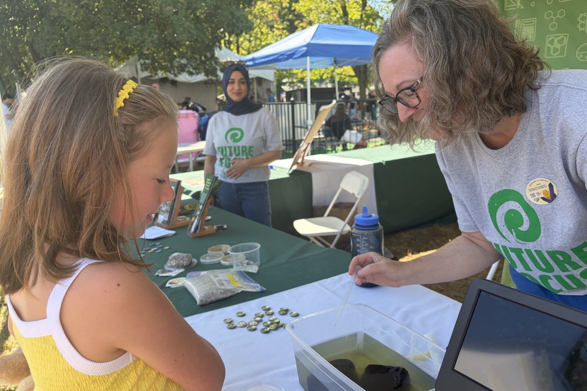 Julie Maresca, associate professor of chemistry at SUNY-ESF, teaches a young fairgoer about microbes in freshwater sponges at the 2026 New York State Fair
