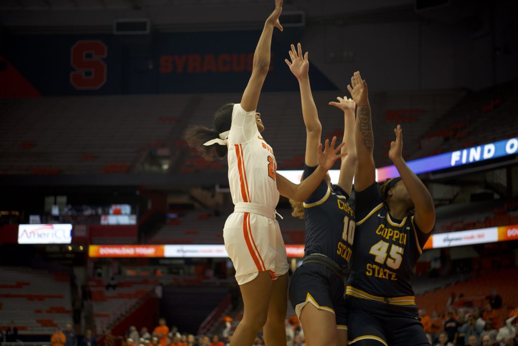 Orange guard Alaina Rice tries to shoot the ball over the Coppin State defenders' hands on Dec. 8, 2022.