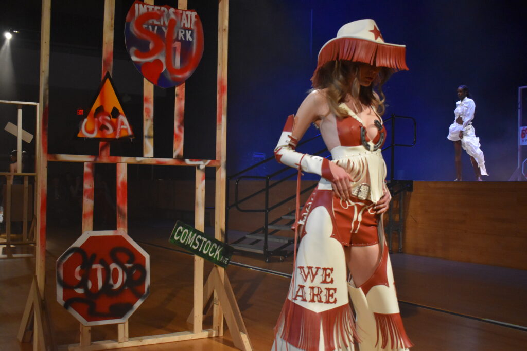 woman in fringe chaps and a fringe cowgirl hat