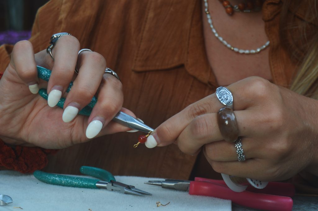 Lilyan Minicozzi works on a piece of jewelry with sustainable materials.