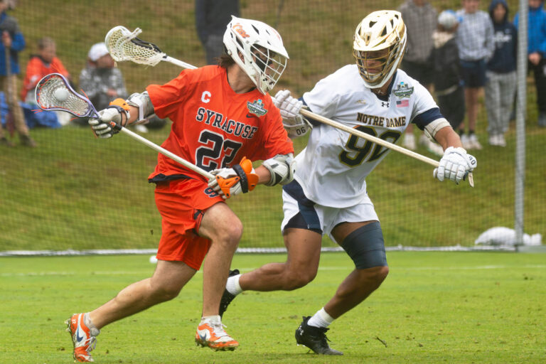 Syracuse senior attack Joey Spallina dodges Notre Dame junior defenseman Shawn Lyght in the NCAA Semifinal on May 23, 2026 at Scott Stadium in Charlottesville, Virginia.