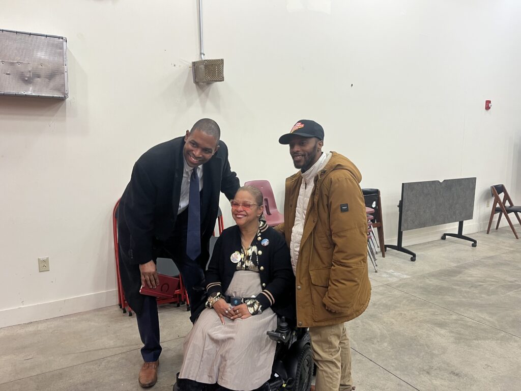 Antonio Delgado (left) poses for photo with community members during State of the People Tour