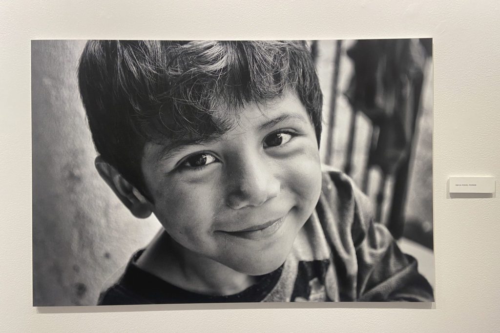 close-up of a boy shot from above grinning at the camera