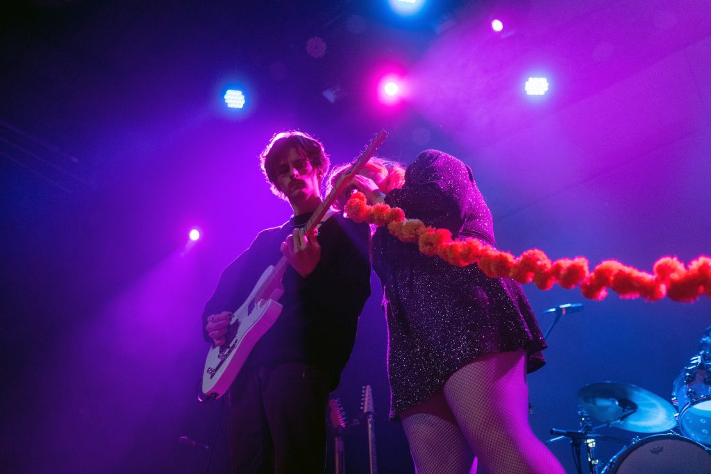 Singer Zoe Reynolds leans on the shoulder of the bassist for Kississippi performing at The Westcott Theater in Syracuse, NY on Thursday, March 3, 2022. (Photo by Spencer Haines/Newhouse School)