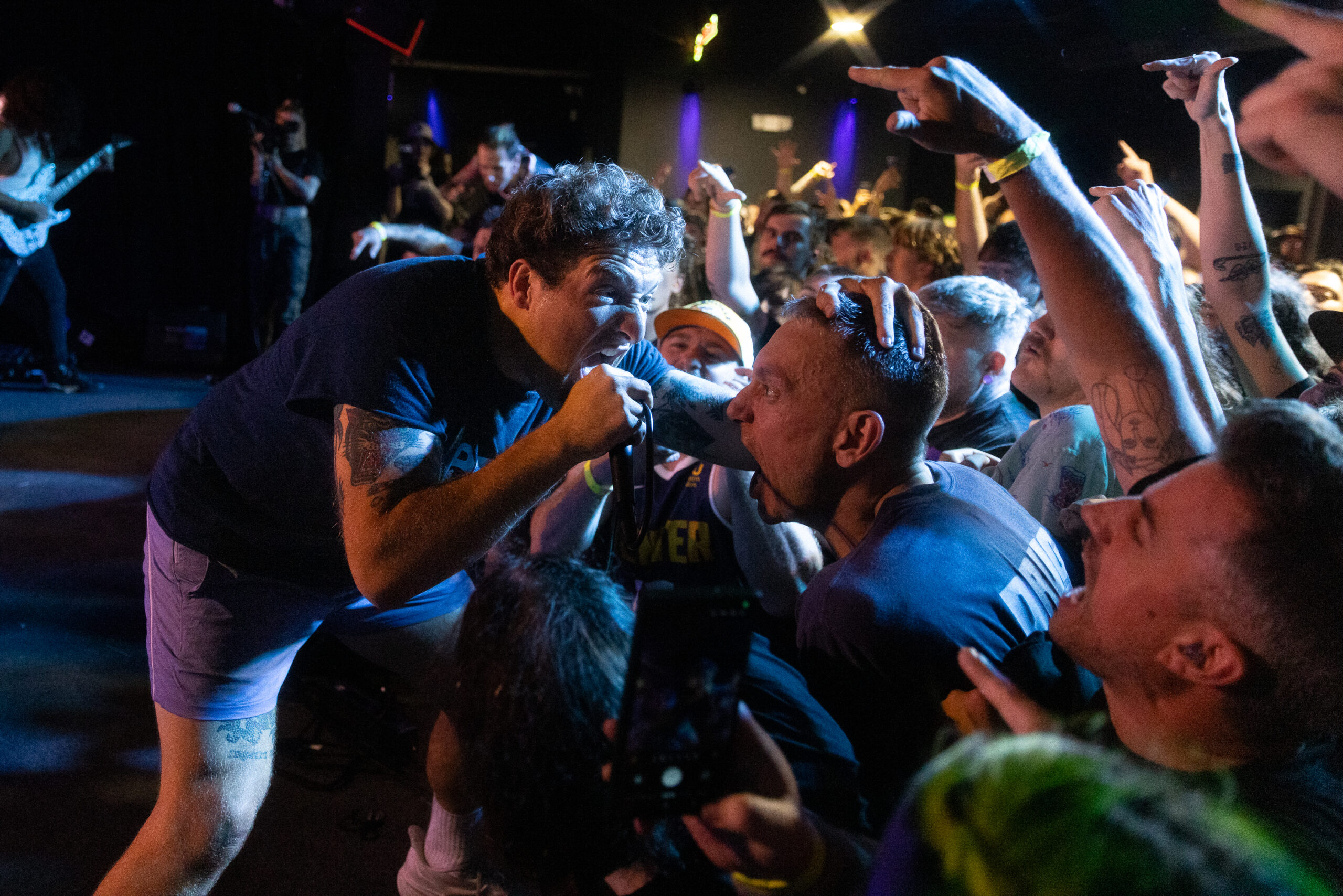 Drain's Sammy Ciaramitaro screams into the mic with a fan during the Warped Tour and Beyond tour Wednesday, June 11, 2025 at The Song & Dance in Syracuse, N.Y. Photo by Kayla Breen.