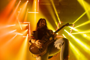 Halestorm guitarist Joe Hottinger shreds under colorful lights at the OnCenter on September 16, 2025. The rock band performed new and old favorites throughout their set.