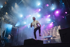 Jack Met of AJR performs under purple stage lights Thursday, Aug. 21, 2025, at Suburban Park Stage during the New York State Fair in Syracuse, N.Y.
