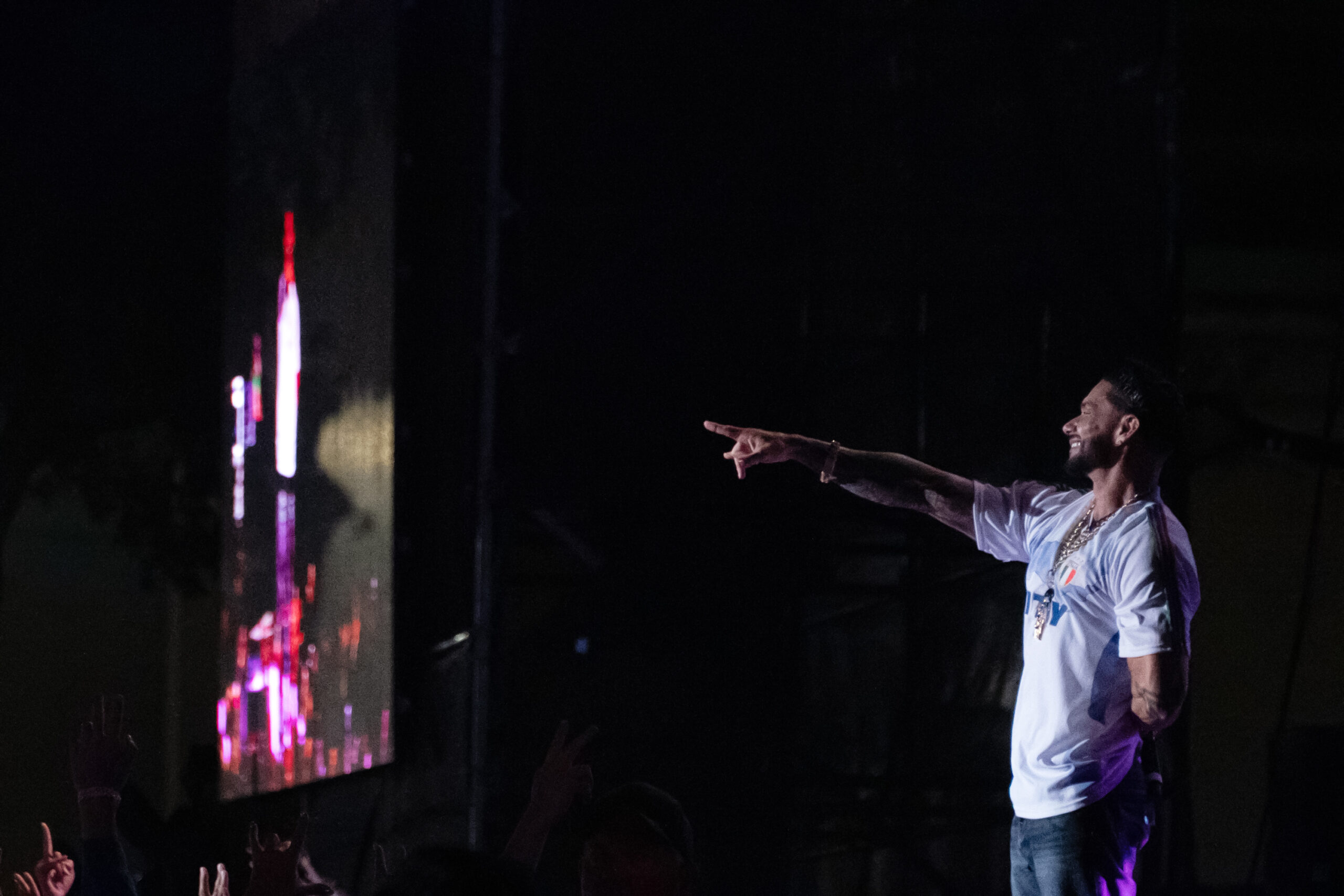DJ Pauly D in a white shirt and jeans points out to the crowd near the end of his set on the Chevy Court stage at the New York State Fair.