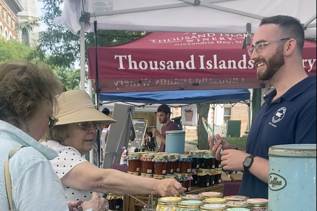 Eric Sugrue, of Dragonfly Jams and Jellies, offers Syracuse Arts & Crafts Festival visitors samples of nine different types of jam.