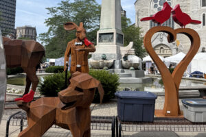 Giant, hand-carved sculptures are for sale near downtown Syracuse's Columbus Circle during the Syracuse Arts & Crafts Festival.