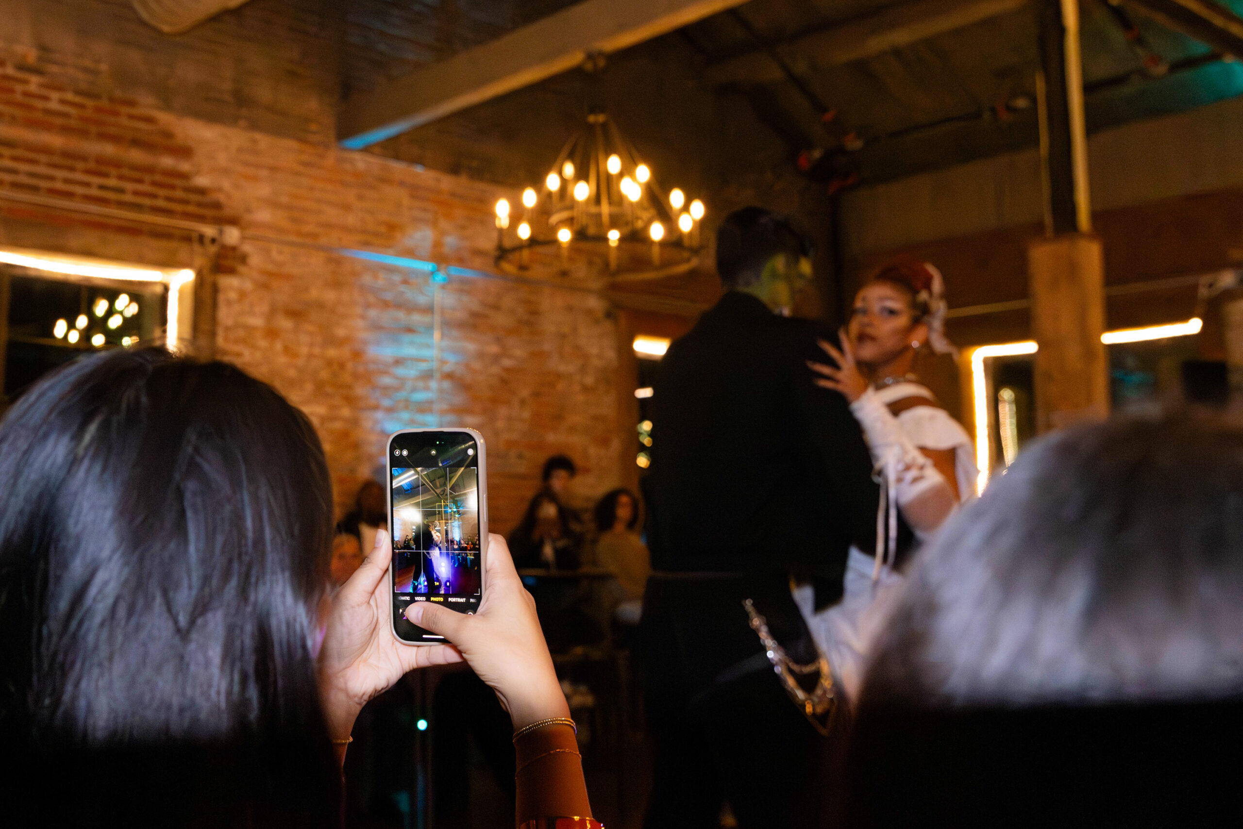 A Glam Slam audience member photographs MAZE Studios' contest-winning Frankenstein-inspired performance on October 2, 2025. Models Aryana Josephs and Gavin Schiavi entertained the audience and judges alike. 