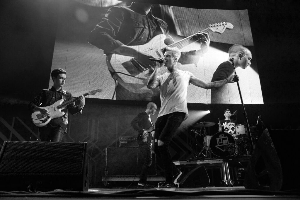 Musician Zack Abels (L) and singer Jesse Rutherford (R) of The Neighbourhood performs onstage at the 24th Annual KROQ Almost Acoustic Christmas at The Shrine Auditorium on December 8, 2013 in Los Angeles, California.