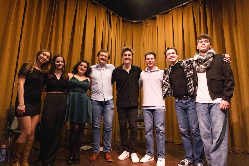 From left to right, cast members Mary Potter, Caroline Nuzzo, Emily Koubeck, Robbie Moseley, Matthew Dodaro, Grant LaMartina, Reed Grayner and Samuel Reinhard pose after their performance of Tick, Tick... BOOM! at Syracuse Stage on Nov. 20, 2025. Dodaro, a senior musical theatre major, made his directorial debut with Black Box Players with this performance.