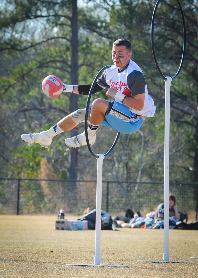 Chris Champitto jumping through a Quidditch hoop.