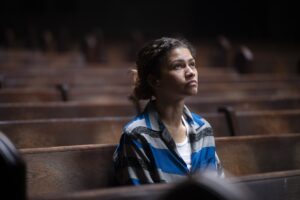 In "Euphoria" Season 3 Rue sits alone in a wooden pew in a church, staring up.