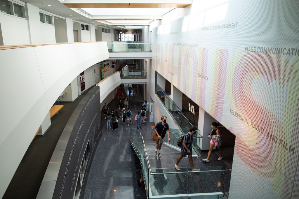 Students walk to their in-person classes in Newhouse 3 on Monday.