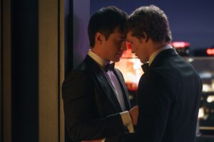 In "Heated Rivalry" two men in suits rest their heads against each other after a passionate kiss.