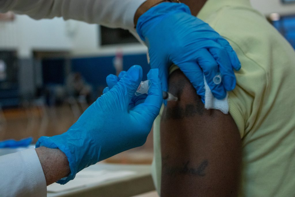 A man receives a COVID-19 vaccination shot at a Syracuse clinic earlier this year.