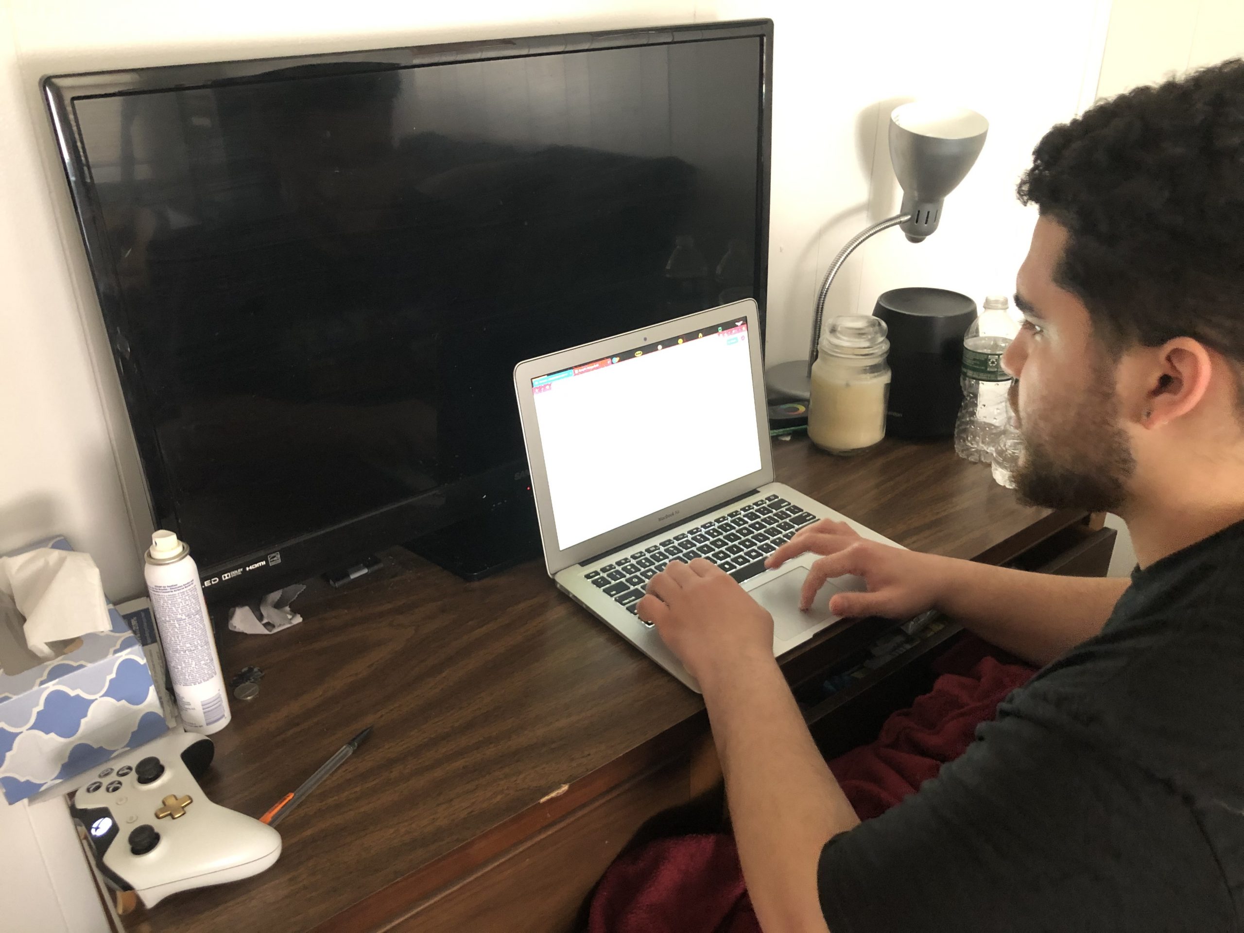 Jaylen Barron begins an essay at his desk at home, where he balances a busy class schedule with work and hobbies.