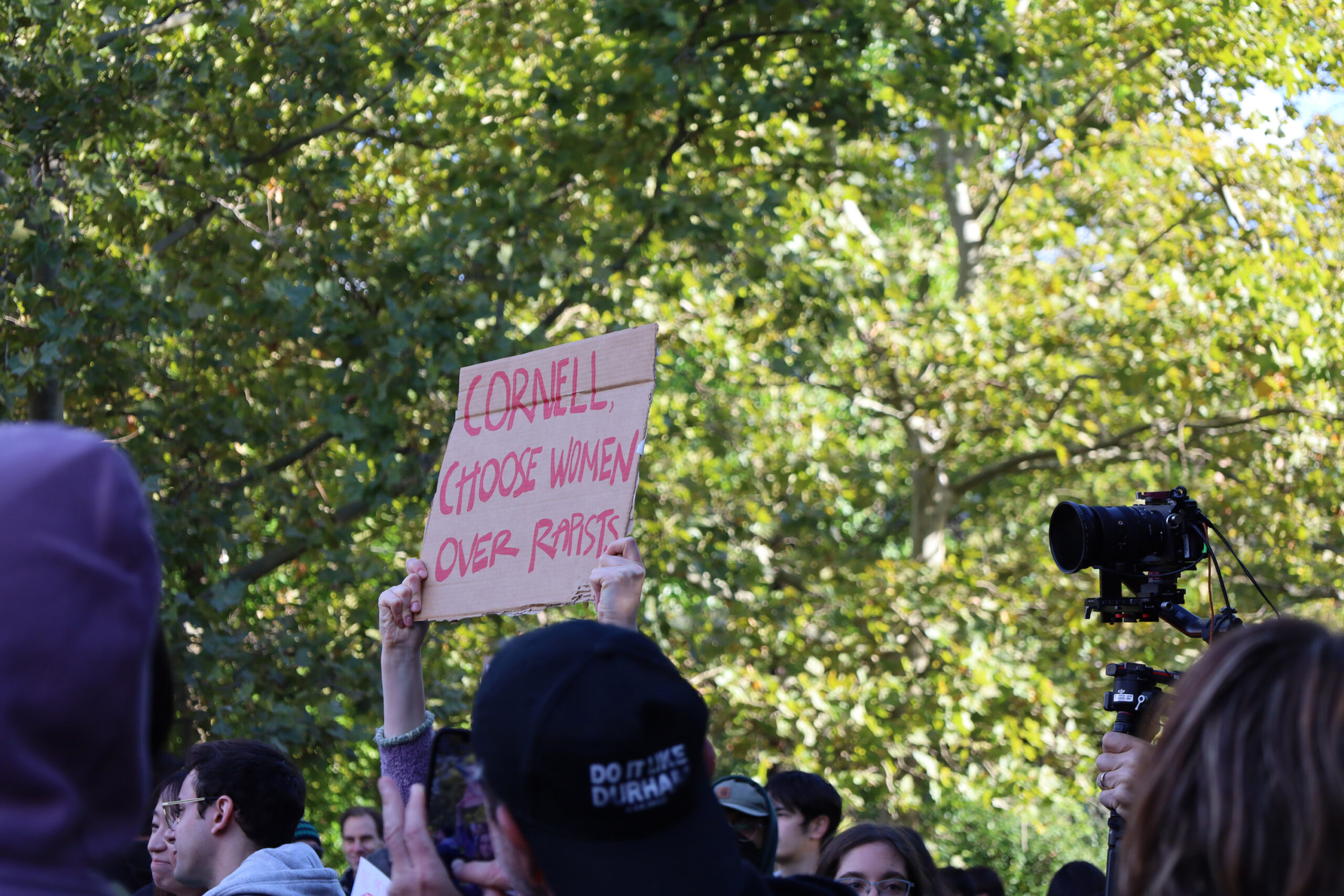 A sign held about the head of a protestor onCornell University's campus on Oct. 5, 2026, during a march to protest the administration's handling of a 2024 gang rape alleged at Chi Phi fraternity house.