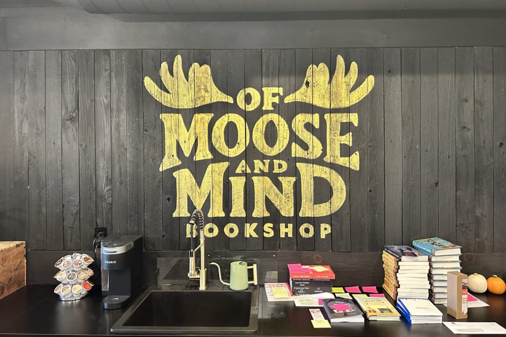 Against a wooden wall yellow text reads 