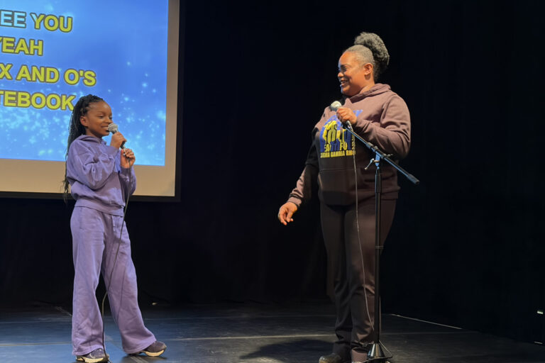 Two community members sing on stage during the Black History Month Karaoke event on Thursday at the Community Folk Arts Center.