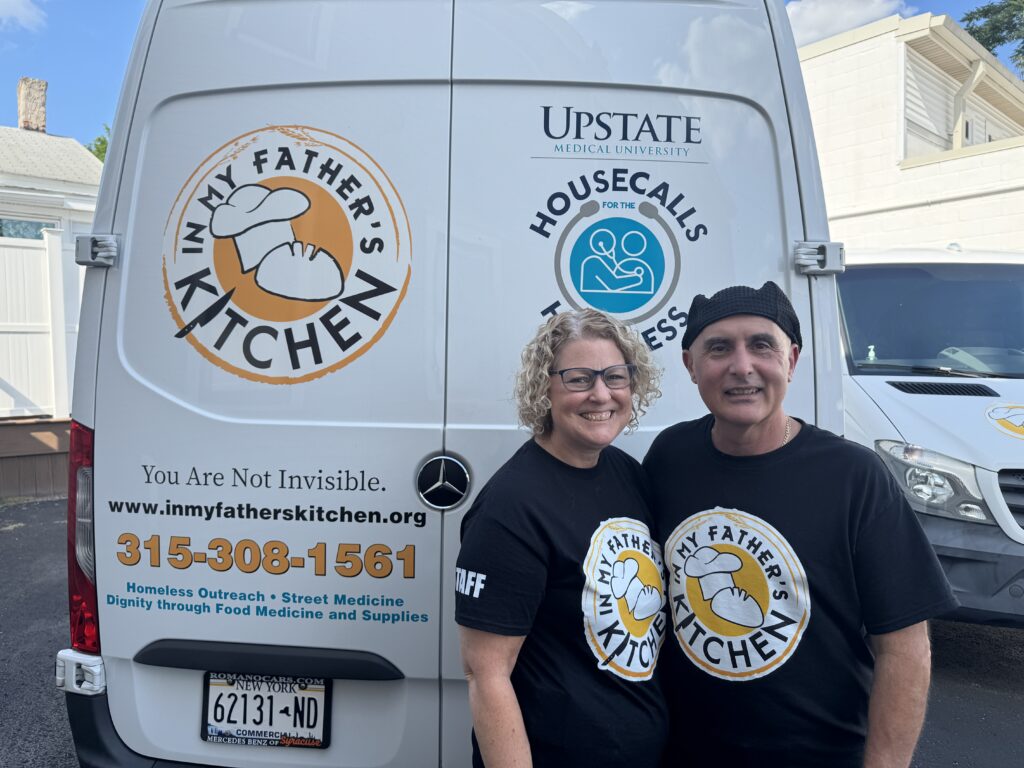 Photo of John and Leigh-Ann Tumino in front of the In My Father's Kitchen van. 