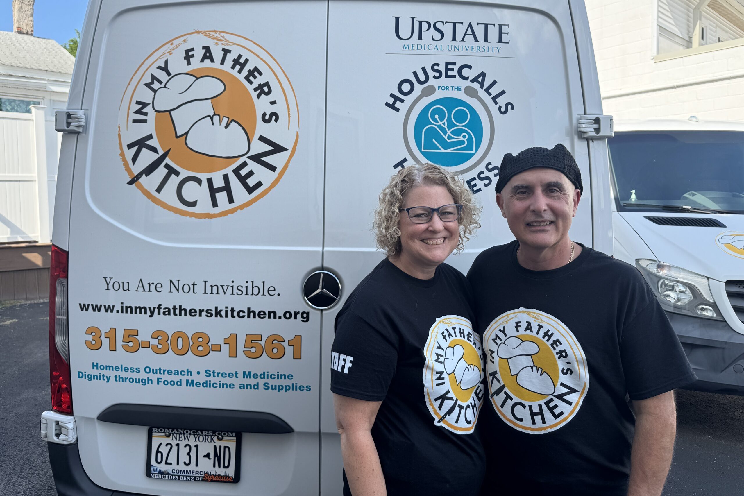 Photo of John and Leigh-Ann Tumino in front of the In My Father's Kitchen van.