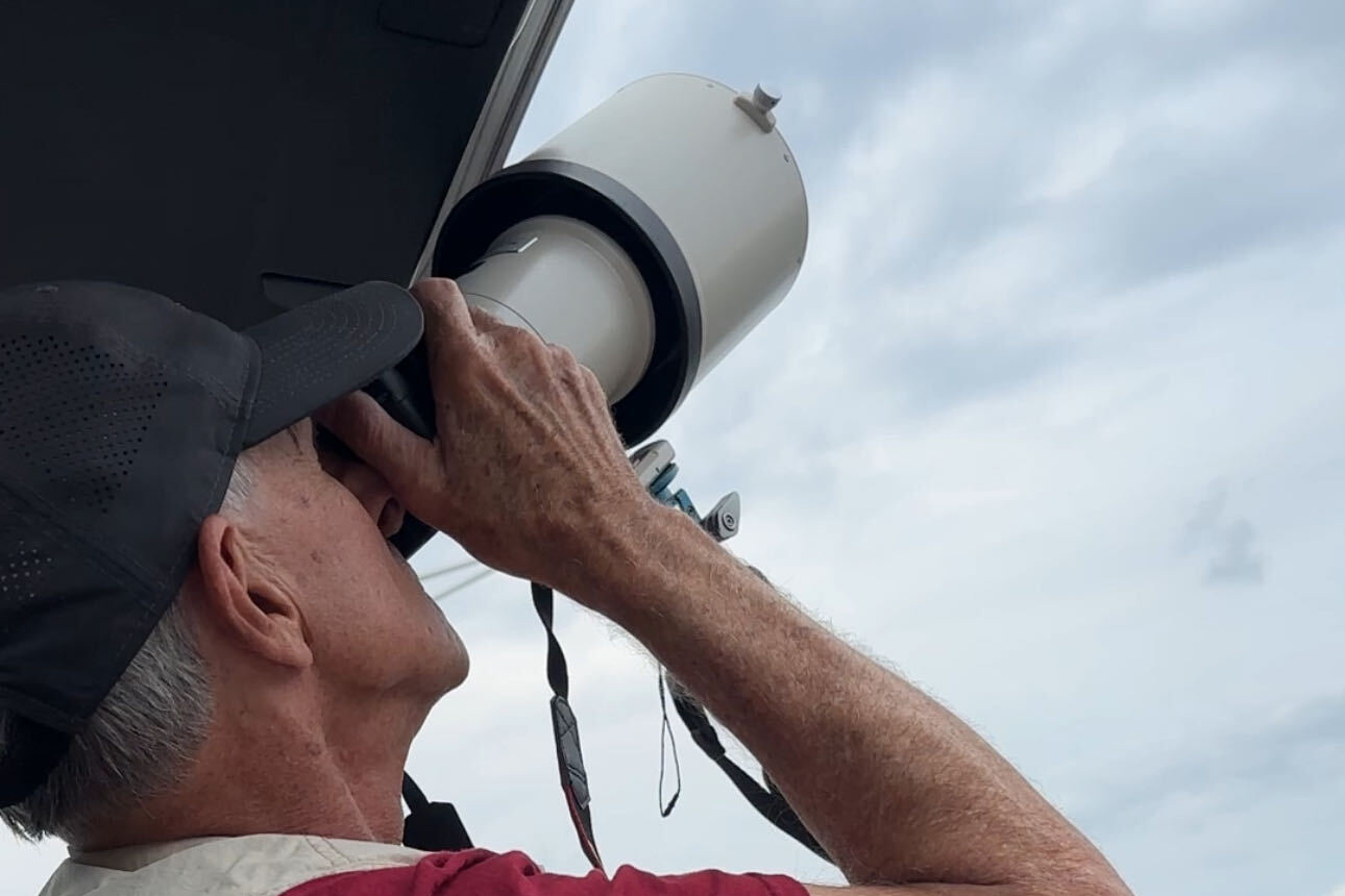 Mike Greenlar gets a juvenile eagle into focus, out photographing birds on the shores of Onondaga Lake.