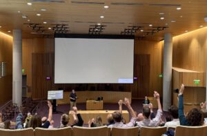 University Senate members raise their hands during the first session of the year.