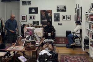 Cjala Surratt, owner of Black Citizens Brigade, speaks with visitors inside her downtown Syracuse shop, which combines vintage clothing, books and records with community programming and conversation.
