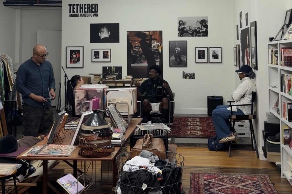 Cjala Surratt, owner of Black Citizens Brigade, speaks with visitors inside her downtown Syracuse shop, which combines vintage clothing, books and records with community programming and conversation.