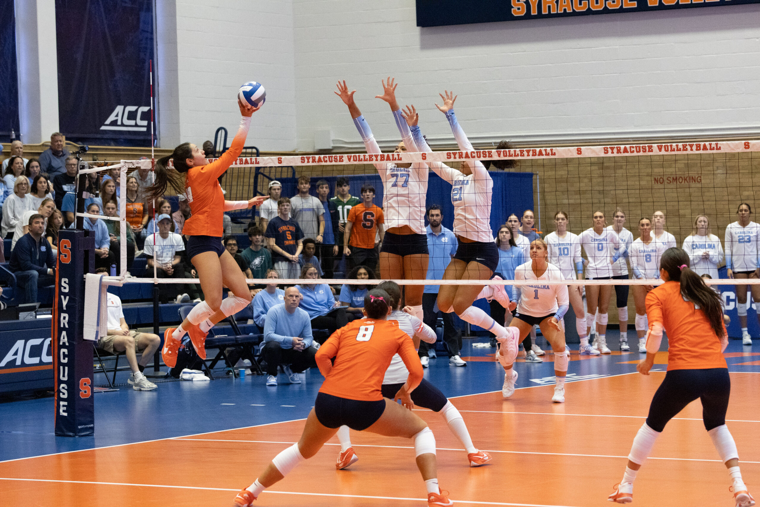 Gabby McLaughlin (18) tips ball over net defended by two UNC players at the Women’s Building on Sunday, Oct 19.