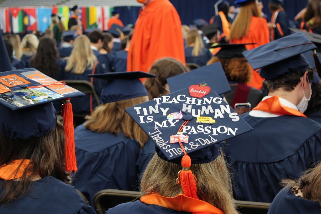 A 2020 SU graduate sits before the September 19, 2021 Commencement ceremony in the Dome on September 19th, 2021a.