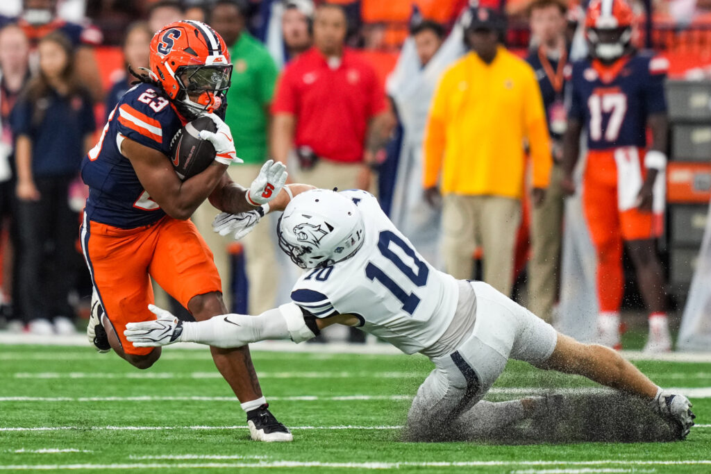 Running back Shavane Anderson ran past a diving tackle from Wildcats safety Cohen Cook.