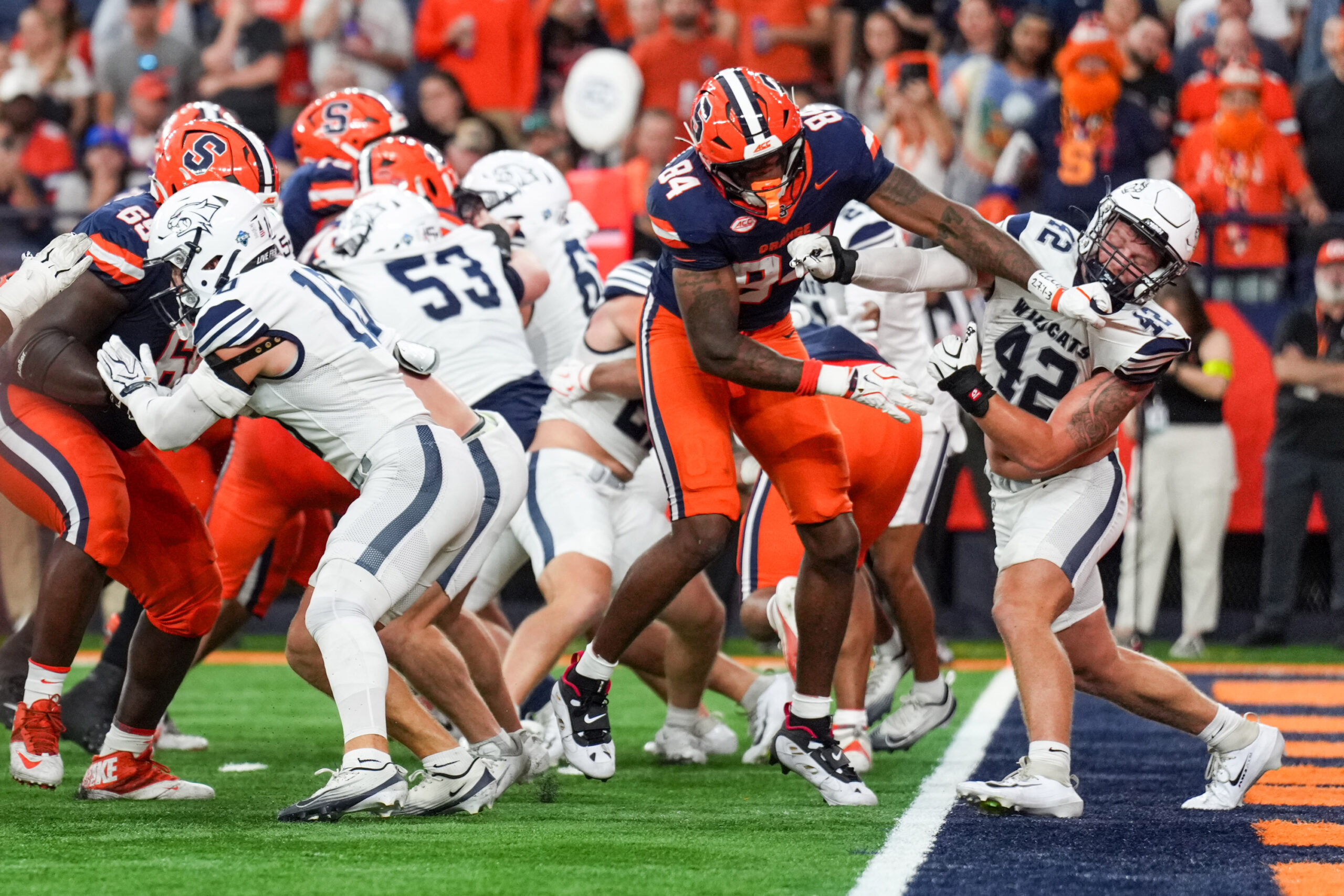 Tight end Elijah Washington-Baker shoved Wildcats linebacker Trevor Barry.
