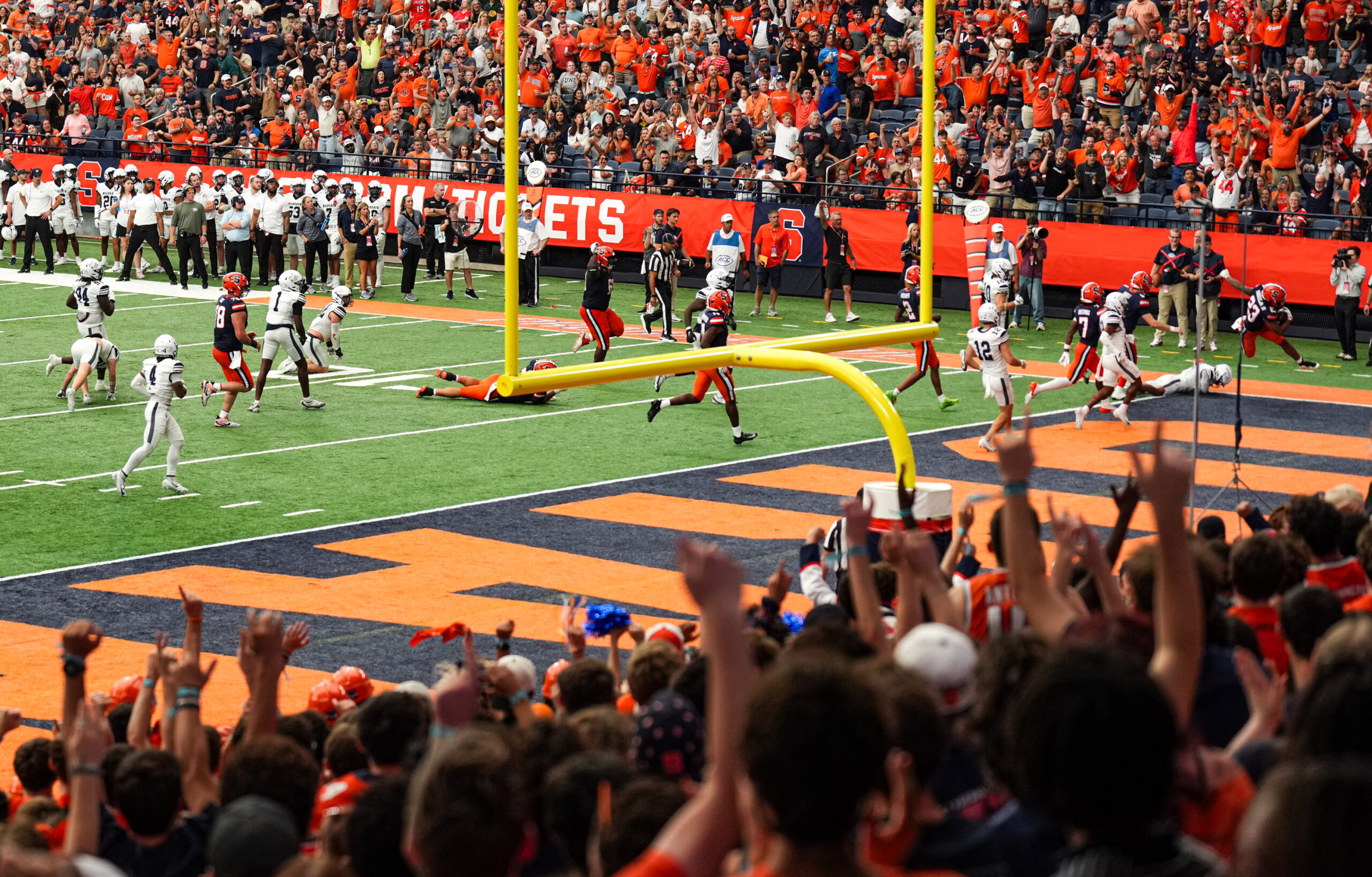The Orange are pictured scoring one of nine touchdowns commanding a 66-3 blowout win.